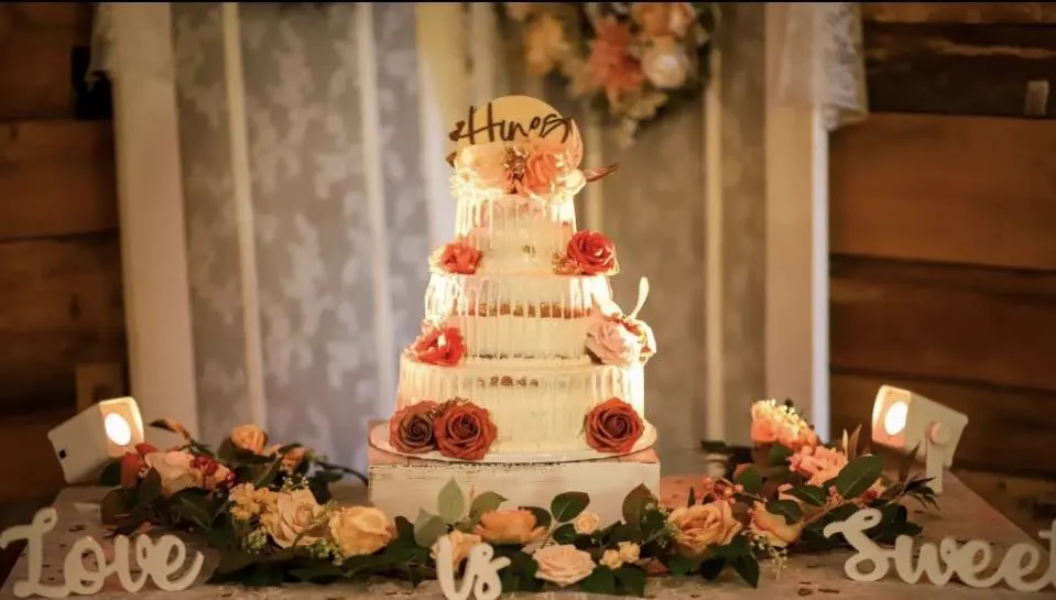 Custom 3-tier drip wedding cake with roses in Whiteville NC by Christy's Cakes